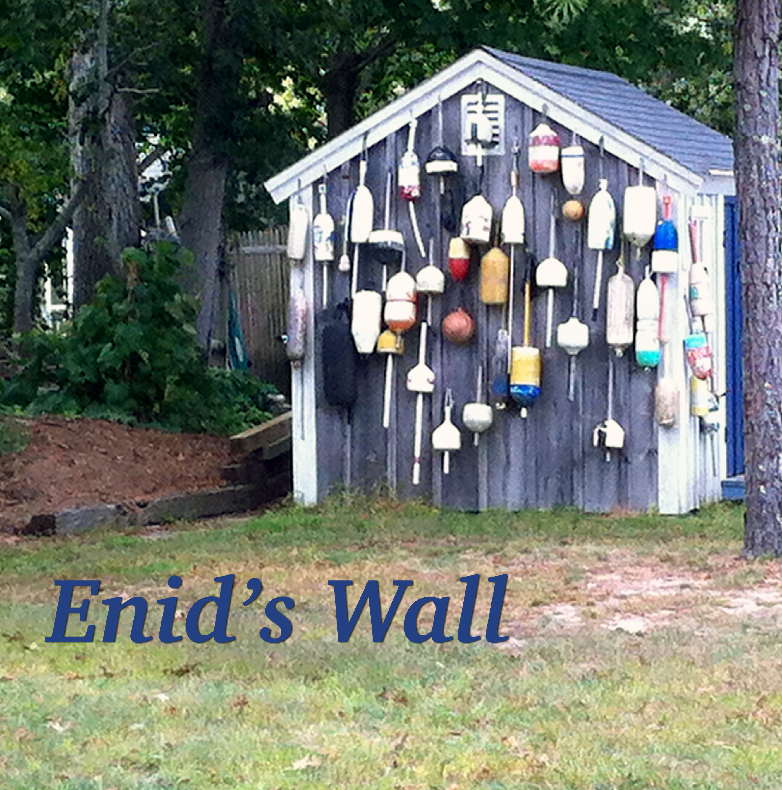 Photo of a small wall covered in lobster buoys.